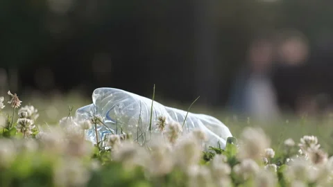 Man in yellow gloves picks up a plastic bottle Stockbeeldmateriaal 136847711