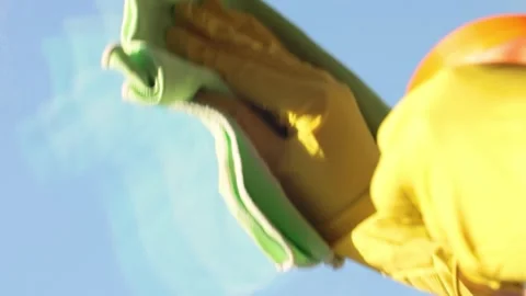 A man in yellow gloves washes a window. Sprays window cleaner onto a dirty .. Stock Footage 322613192