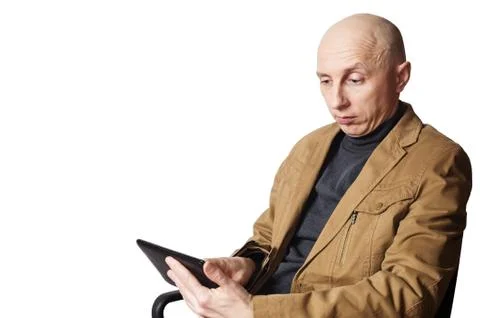 Man in the yellow jacket looking at tablet computer Stock Photos
