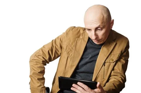 Man in the yellow jacket looking at tablet computer Stock Photos
