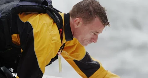Man In Yellow Jacket Preparing To Go Sea Kayaking In The Ocean Stockbeeldmateriaal 64310781