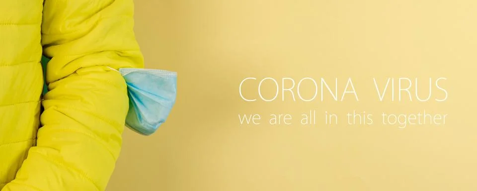 Man in yellow jacket is using a protective mask against corona virus on yello Foto stock