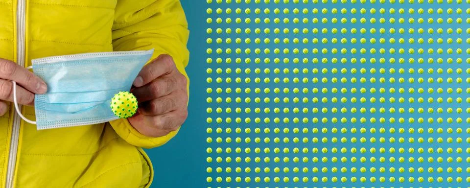 Man in yellow jacket is using a protective mask against corona virus on blue  Stock Photos