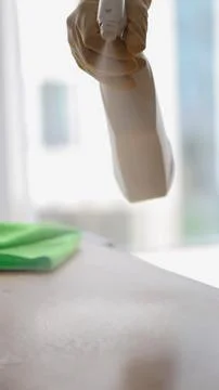 Man in yellow protective gloves dusting with cleaning agent Stock Photos