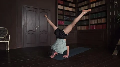 Man Yoga Instructor Performs Power Exercise At Home Stock Footage 152570542