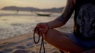 Man With Yoga Necklace Meditating On Beach Stock Footage