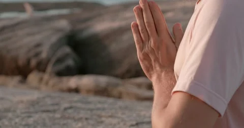 Man in yoga pose at sunset rocks at background namaste hands close-up. Namaste Stock Footage 274518487