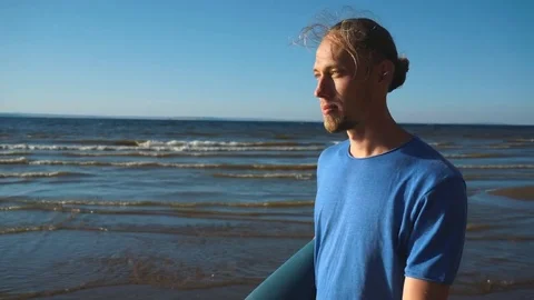 A man with a yoga rolls walking on the beach Stock Footage 80794589