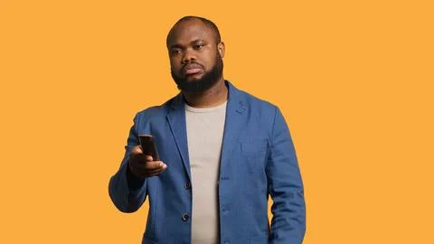 Man zapping through various TV channels, looking for entertaining content Stock Photos
