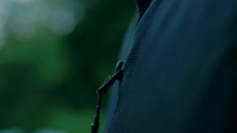 A man zip up a black jacket Stock Footage 138691089