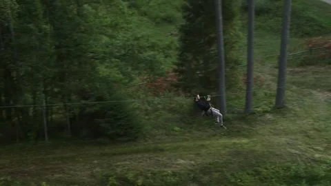 Man Zip Line from Tree to Tree Stock Footage 263040055