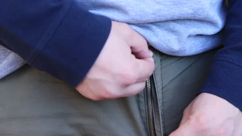 The man zips up his pants. Stock Footage 245411523