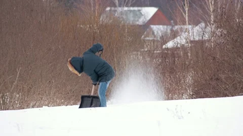 Man_throwing_snow_with_spade_in_winter Stock Footage 130235244