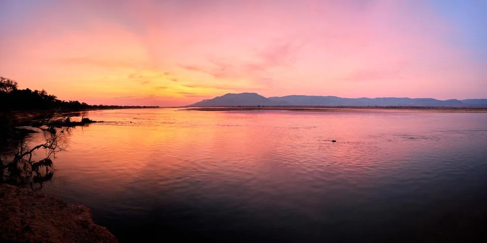 Mana Pools scene. Panoramic view of red sunset on african Zambezi river. The  Stock Photos