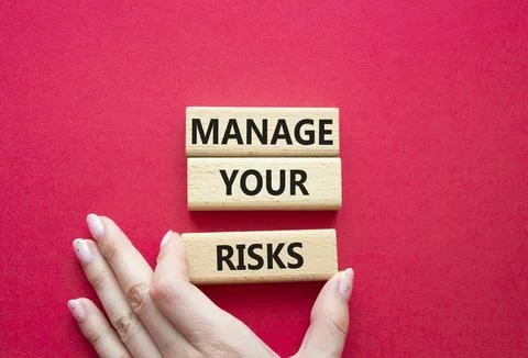 Manage your Risks symbol. Concept words Manage your Risks on wooden blocks... Stock Photos