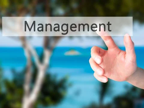 Management - Hand pressing a button on blurred background concept on visual s Stock-Fotos