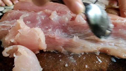 Management Raw fish meat is scraped with a spoon on a wooden cutting board. Video stock 305258927