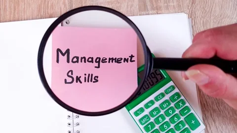 Management Skills text, word note on paper through a magnifying glass. Stock Footage 313432099