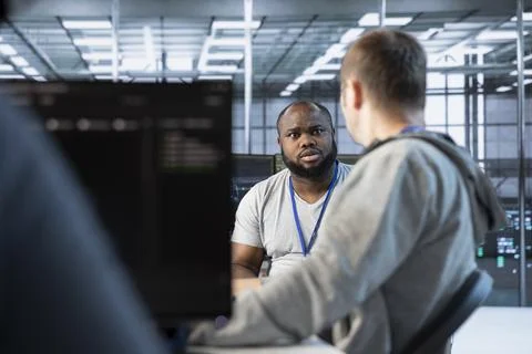 Manager admonishing developer after making error in data center Stock Photos