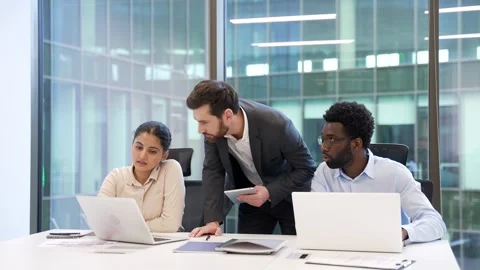Manager advises subordinate female worker using laptop in modern business office Stock Footage 322222325
