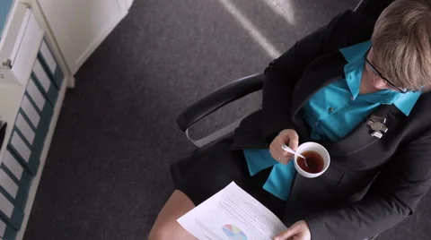 Manager analyzes documents and drinking coffee Stock Footage 49072650