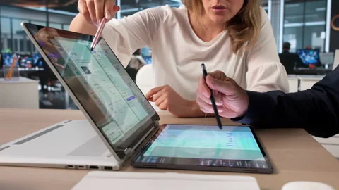 Manager And Assistant Review Digital Documents Using Laptop Stock Footage 336367382