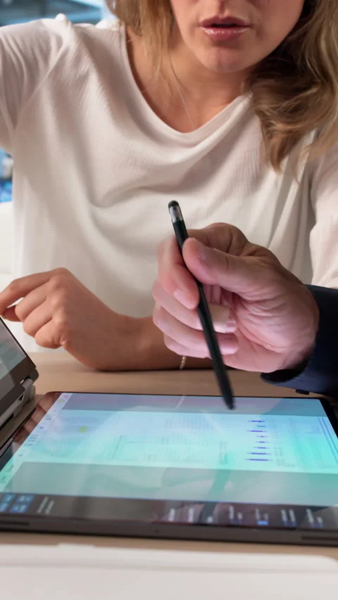 Manager And Assistant Review Digital Documents Using Laptop Stock Footage 336369124