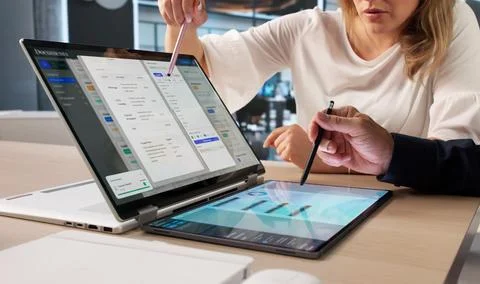 Manager And Assistant Use Laptop Reviewing Digital Documents Together Securel Stock Photos