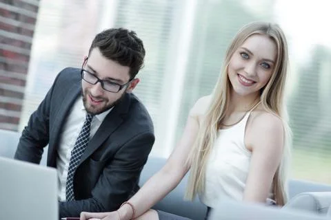 Manager and client browsing information on the laptop. Stock Photos