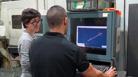 Manager and engineer using computer in a cnc metallurgic factory Stock Footage 293320736
