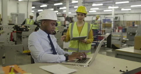 Manager and foreman in a factory discussing inventory. Stock Footage 49105672