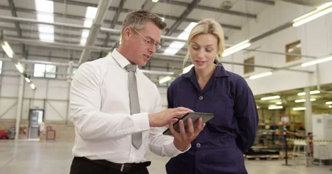 Manager and foreman in a factory using a digital tablet at a production line Stock Footage 52756493