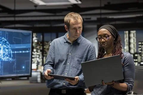 Manager and intern in office automating repetitive tasks using AI 写真素材