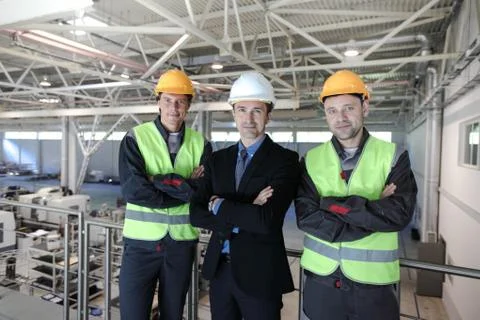 Manager and workers in factory Stock Photos