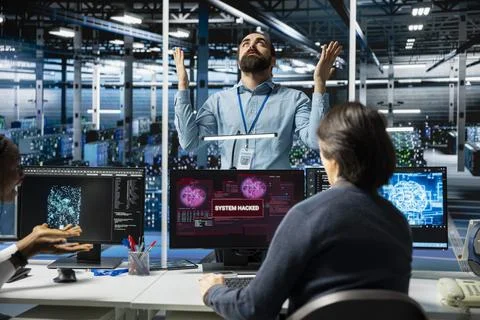 Manager angry with technicians in AI server farm letting hacker steal data Stock Photos