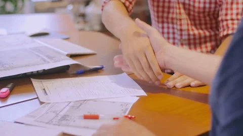 The manager approved work of the employees and shook hands with one of them Stock Footage 58017133