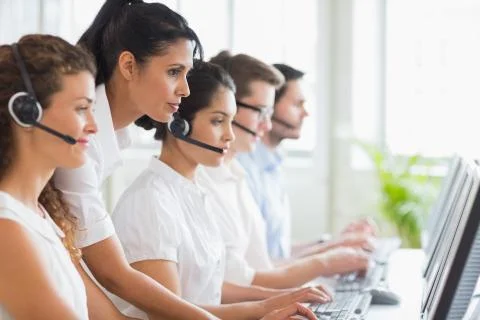 Manager assisting her staffs in call center Stock Photos