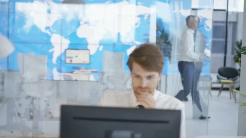 Manager assisting his colleague with work in office Stock Footage 108102740