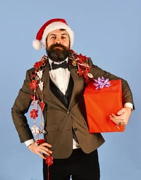 Manager with beard holds red gift. Man in smart suit Stock Photos