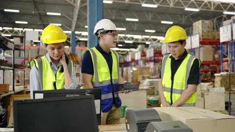 The manager is blaming the workers inside the warehouse Stock Footage 224707209