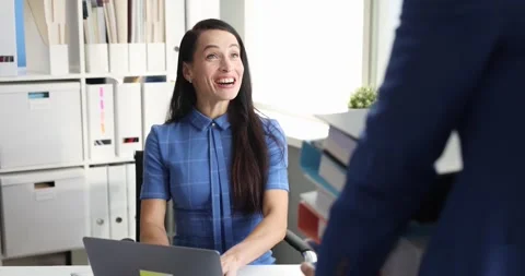 Manager brings many folders to young woman secretary to work with documents slow Stock Footage 257664985