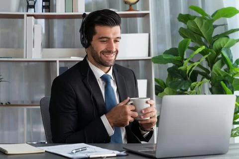 Manager of call center operator office sitting on his desk with coffee. fervent Stock Photos