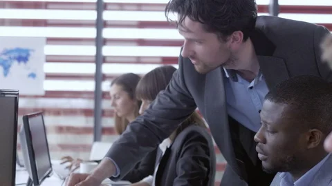 Manager checking employee's work and discussing the details Stock Footage 74293129