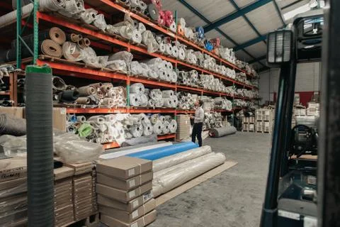Manager checking his warehouse stock using a clipboard Stock Photos