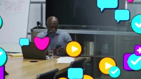 Manager checking smartphone at table, causing social media icons to multiply and Stock Footage 333019685