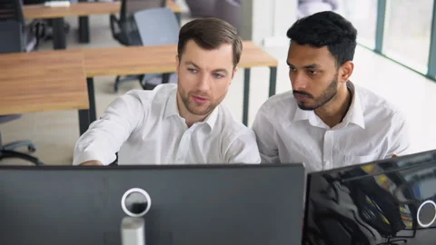 Manager consulting indian client with online technology at office meeting. Two Video stock 265110827