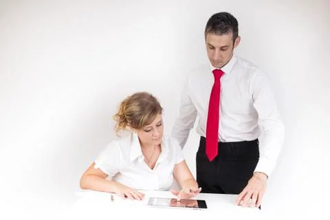 Manager controls the secretary while work with the tablet Stock Photos
