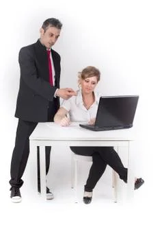 Manager controls the secretary while work with computer Stock Photos