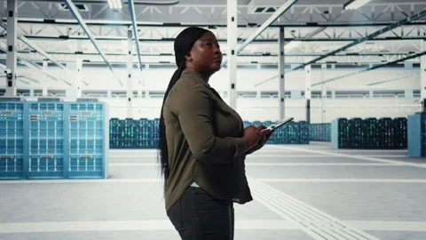 Manager in data center using tablet to deploy new server architecture Stock Footage 317125970