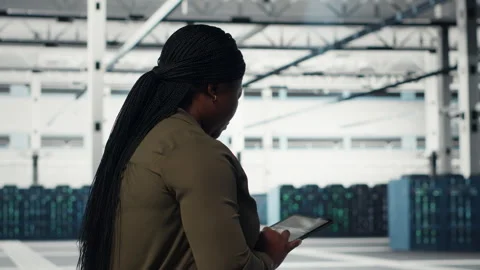 Manager in data center using tablet to deploy new server architecture Stock Footage 317203531